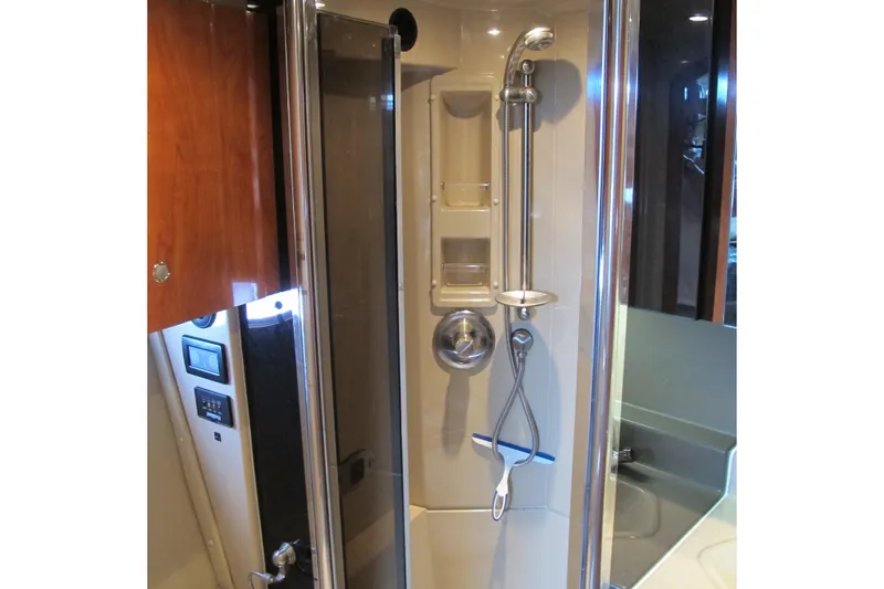 Slide: The Image of Shower area in 2006 Cruisers Yachts 385 Motoryacht, featuring modern fixtures and wood accents. - 43