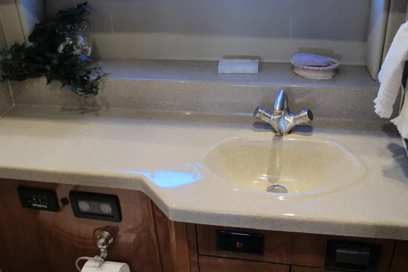 Slide: The Image of Bathroom sink area in 2006 Cruisers Yachts 385 Motoryacht, featuring modern fixtures and decor. - 55