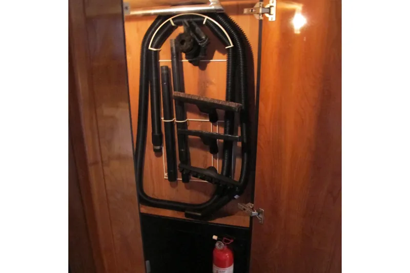 Slide: The Image of 2006 Cruisers Yachts 385 Motoryacht interior with vacuum hose and fire extinguisher. - 57
