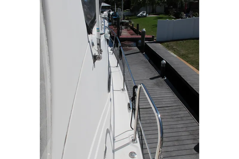 Slide: The Image of 2006 Cruisers Yachts 385 Motoryacht docked, side view with railing and walkway. - 59