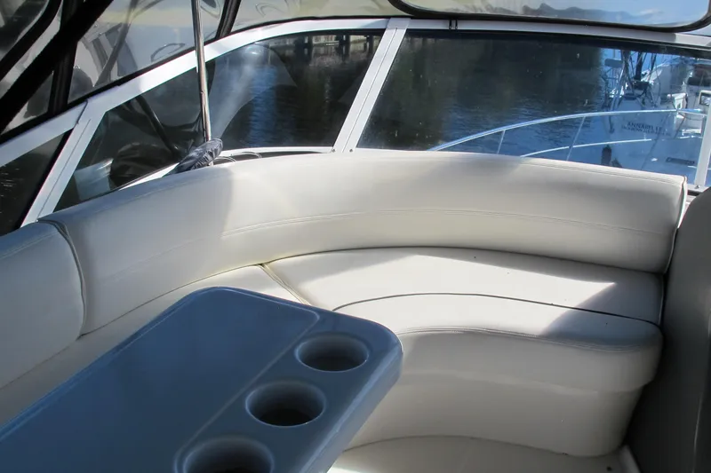 Slide: The Image of Interior of 2006 Cruisers Yachts 385 Motoryacht with white seating and cup holders. - 18