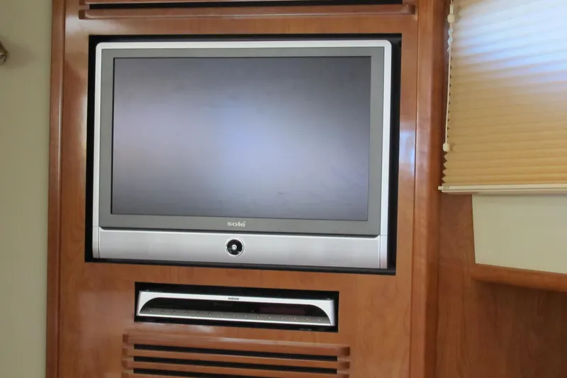 Slide: The Image of Flat-screen TV in 2006 Cruisers Yachts 385 Motoryacht interior, wooden paneling. - 33