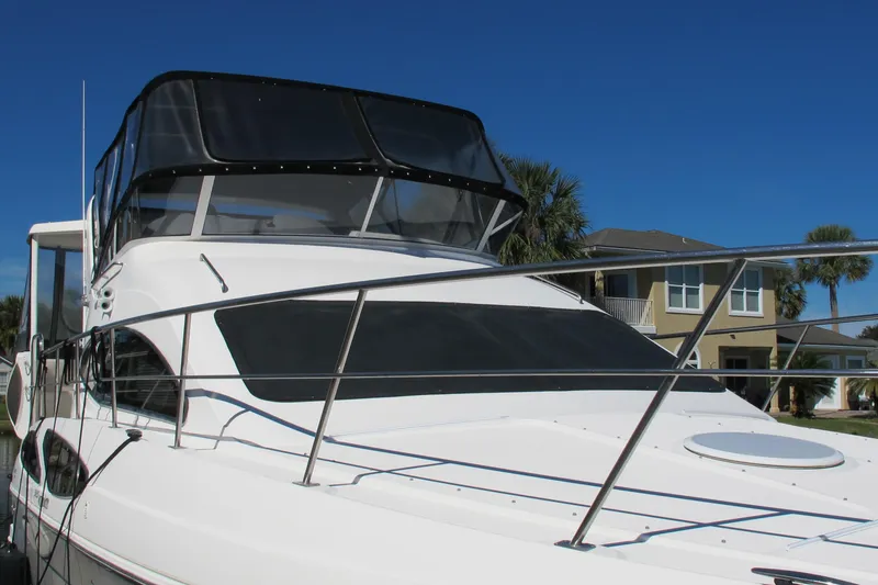 Slide: The Image of 2006 Cruisers Yachts 385 Motoryacht, sleek design, docked under clear blue sky. - 6