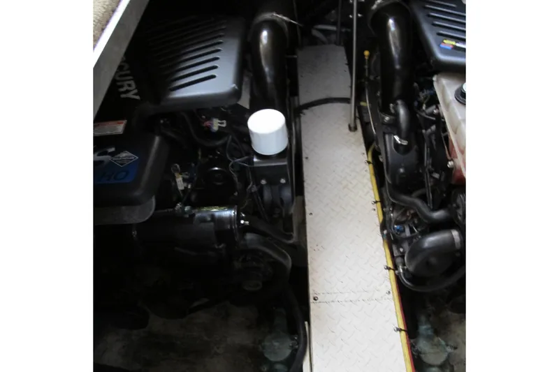 Slide: The Image of Engine compartment of 2006 Cruisers Yachts 385 Motoryacht, featuring dual Mercury engines. - 66