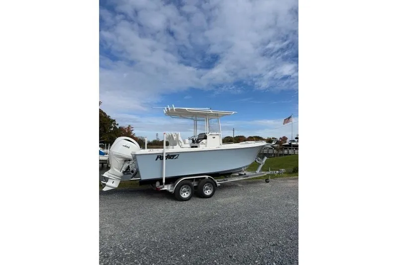 The Image of 2022 Parker 1801 Center Console boat on trailer, parked outdoors under cloudy sky. - 0