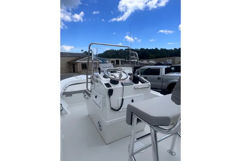 Slide: The Image of 2022 Parker 1801 Center Console boat with steering wheel, parked outdoors. - 4