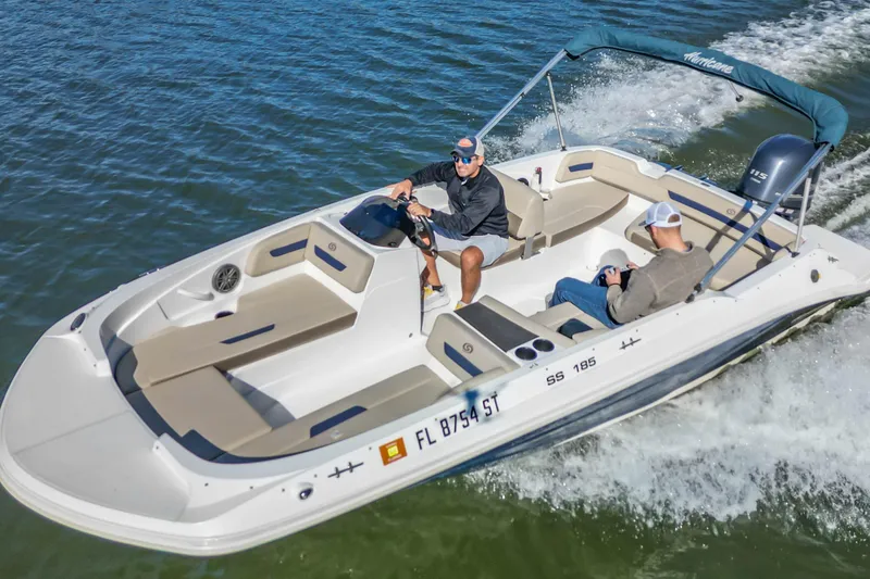 The Image of 2021 Hurricane Center Console SS 211 OB boat cruising on water with two passengers. - 1