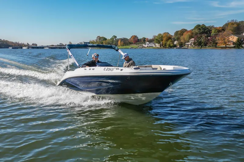Slide: The Image of 2021 Hurricane Center Console SS 211 OB boat cruising on a scenic lake. - 10