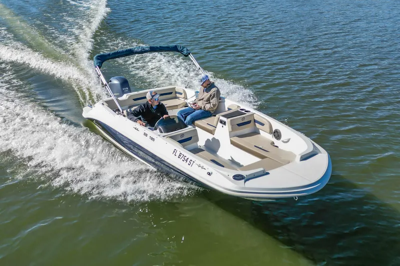 Slide: The Image of 2021 Hurricane Center Console SS 211 OB boat cruising on open water. - 11