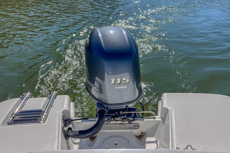 Slide: The Image of 2021 Hurricane Center Console SS 211 OB with Yamaha 115 outboard motor on water. - 17