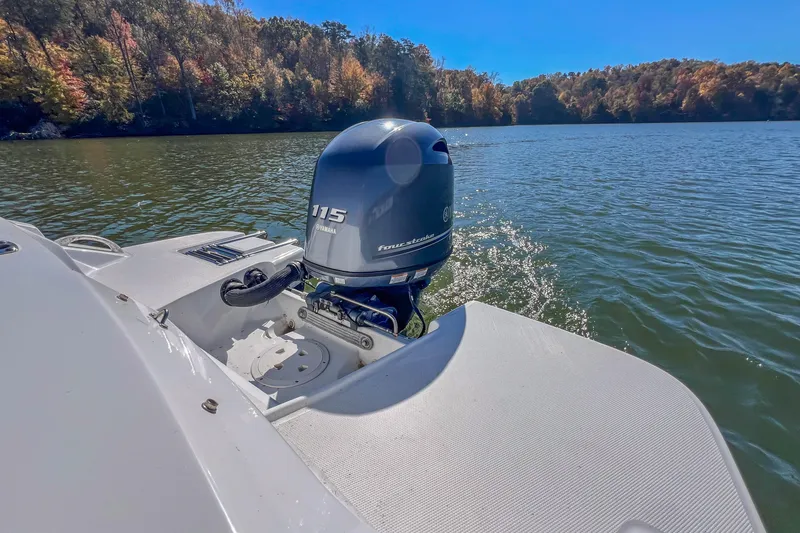 Slide: The Image of 2021 Hurricane Center Console SS 211 OB boat on a scenic lake with Yamaha outboard motor. - 18