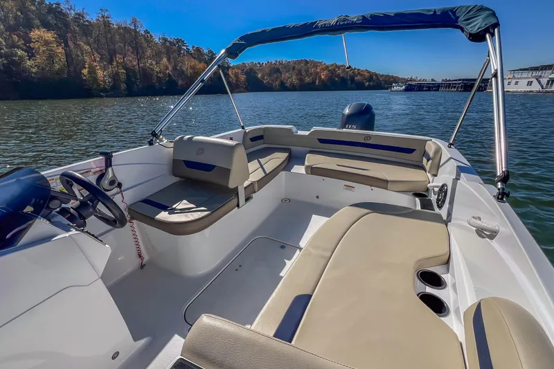 Slide: The Image of 2021 Hurricane Center Console SS 211 OB boat on a serene lake with lush trees. - 22