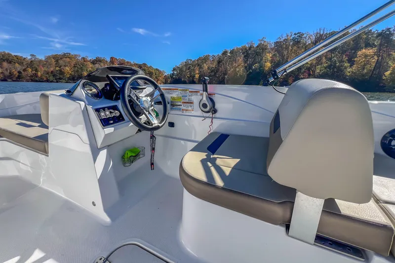Slide: The Image of 2021 Hurricane Center Console SS 211 OB boat interior with steering wheel and seating. - 24