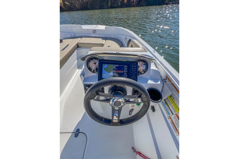 Slide: The Image of 2021 Hurricane Center Console SS 211 OB boat dashboard with steering wheel and navigation display. - 29