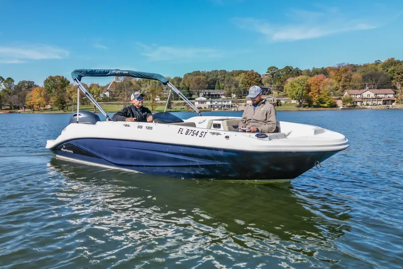Slide: The Image of 2021 Hurricane Center Console SS 211 OB boat on a lake with two people onboard. - 3