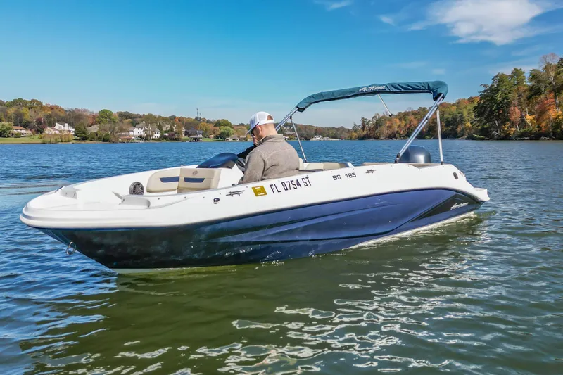 Slide: The Image of 2021 Hurricane Center Console SS 211 OB boat cruising on a scenic lake. - 5