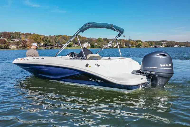 Slide: The Image of 2021 Hurricane Center Console SS 211 OB boat cruising on a scenic lake. - 7