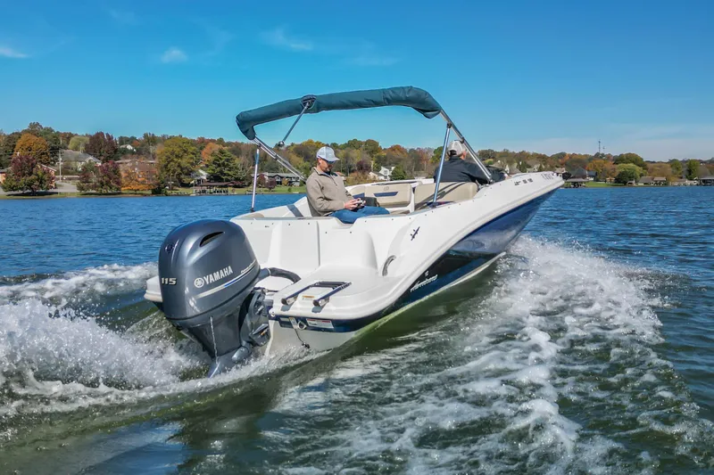 Slide: The Image of 2021 Hurricane Center Console SS 211 OB boat cruising on a scenic lake. - 8