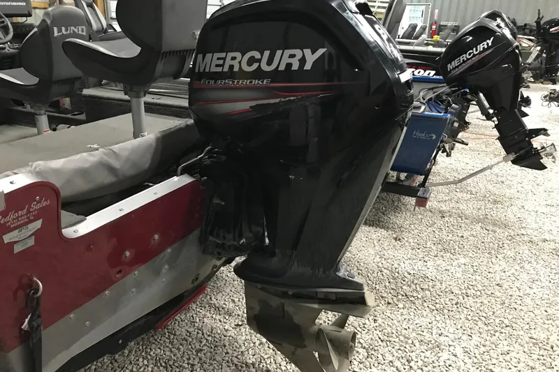 Slide: The Image of 2015 Lund 1675 Impact boat with Mercury FourStroke outboard motor in a showroom. - 10