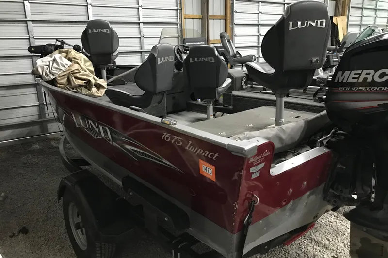 Slide: The Image of 2015 Lund 1675 Impact boat in storage, featuring Mercury FourStroke engine. - 3