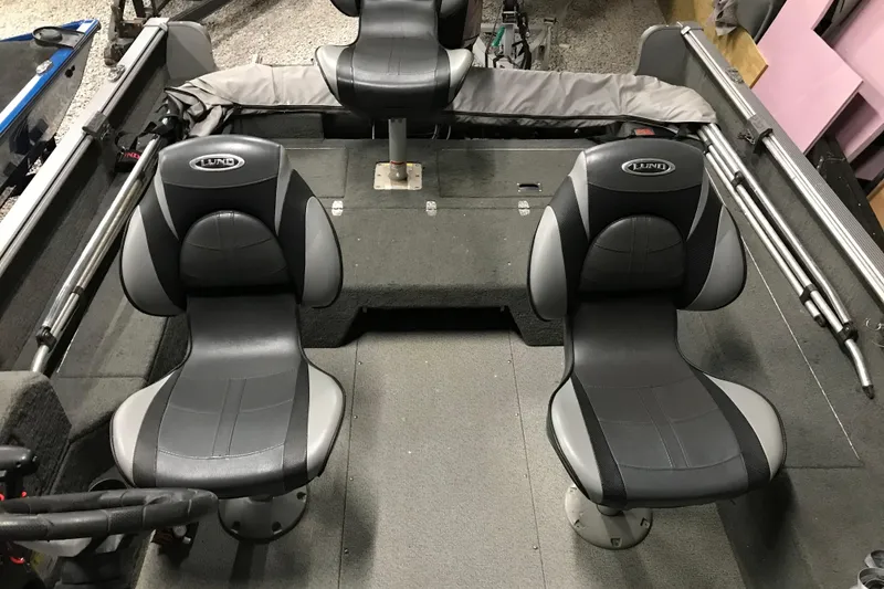 Slide: The Image of 2015 Lund 1675 Impact boat interior with two black and gray seats. - 9