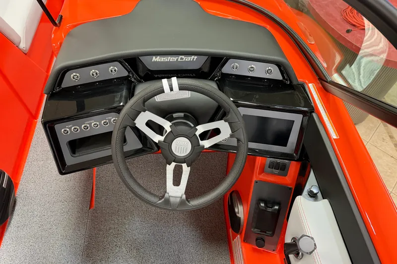 Slide: The Image of 2026 MasterCraft NXT22 boat dashboard with steering wheel and control panel. - 11