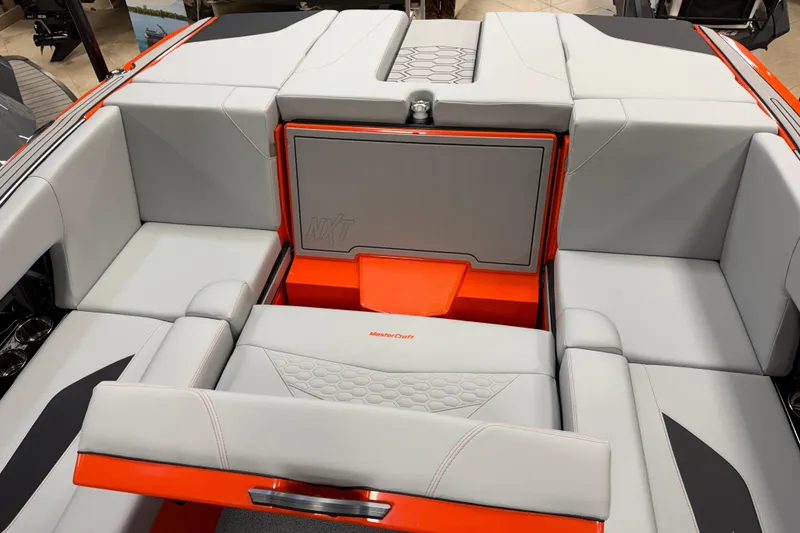 Slide: The Image of 2026 MasterCraft NXT22 boat interior with gray and orange seating, showcasing modern design. - 13