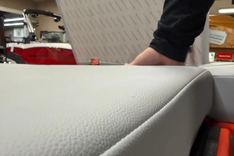 Slide: The Image of 2026 MasterCraft NXT22 boat interior with textured upholstery and visible red exterior. - 16