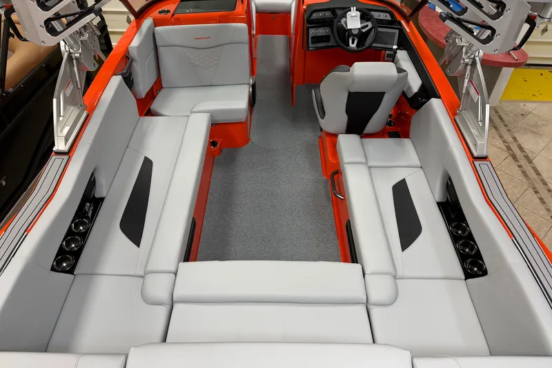Slide: The Image of 2026 MasterCraft NXT22 boat interior with orange and gray seating, modern design. - 3
