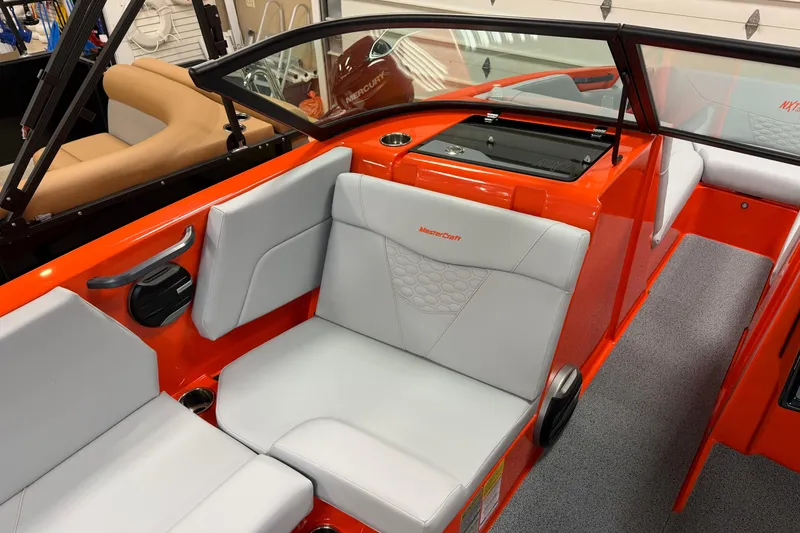 Slide: The Image of 2026 MasterCraft NXT22 boat interior with orange and gray seating, featuring modern design elements. - 4