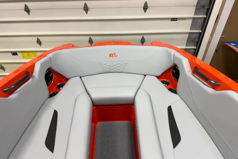 Slide: The Image of 2026 MasterCraft NXT22 boat interior with white and orange seating. - 9