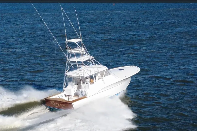 The Image of 2006 Custom Carolina Heritage Express boat cruising on open water. - 0