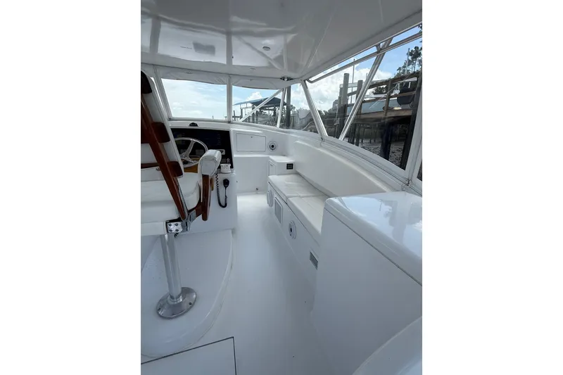 Slide: The Image of 2006 Custom Carolina Heritage Express boat interior with helm and seating area. - 10