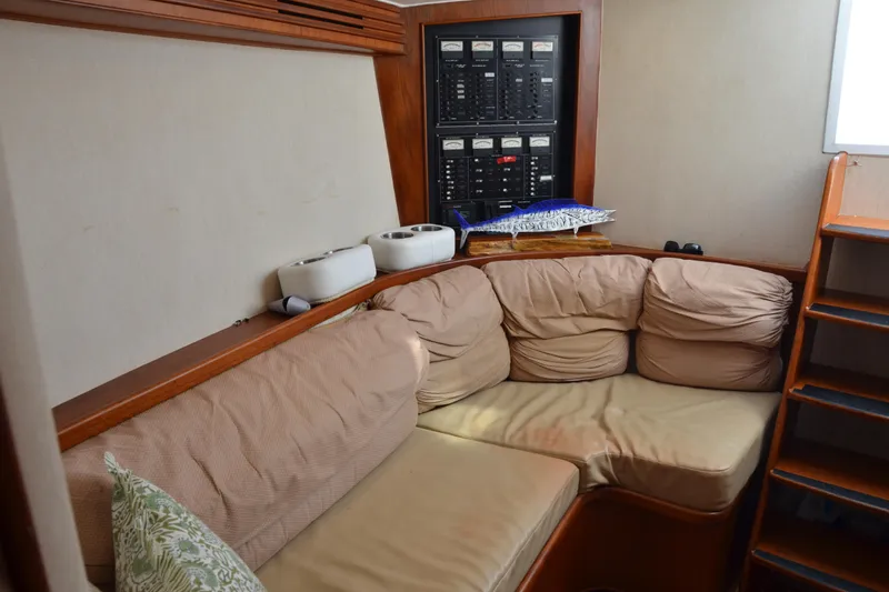 Slide: The Image of Cozy interior of 2006 Custom Carolina Heritage Express boat with cushioned seating and control panel. - 25