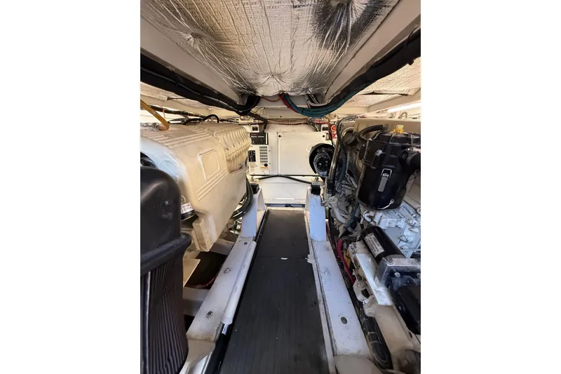 Slide: The Image of Engine room of 2006 Custom Carolina Heritage Express boat, showcasing mechanical components. - 31