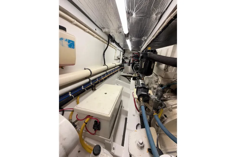 Slide: The Image of Engine room of 2006 Custom Carolina Heritage Express boat, showcasing mechanical components. - 32