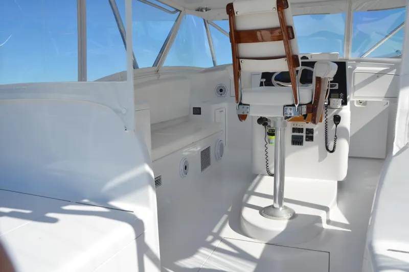 Slide: The Image of 2006 Custom Carolina Heritage Express boat interior with captain's chair and control panel. - 6