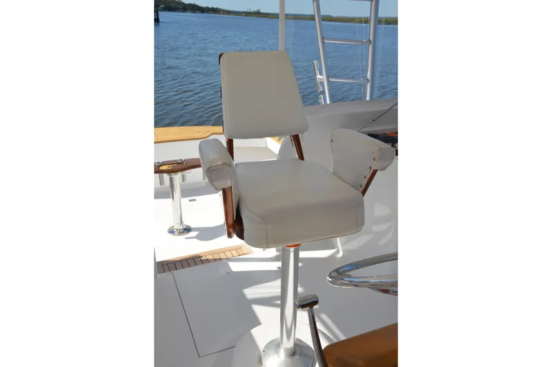Slide: The Image of Captain's chair on 2006 Custom Carolina Heritage Express boat, overlooking serene water. - 7
