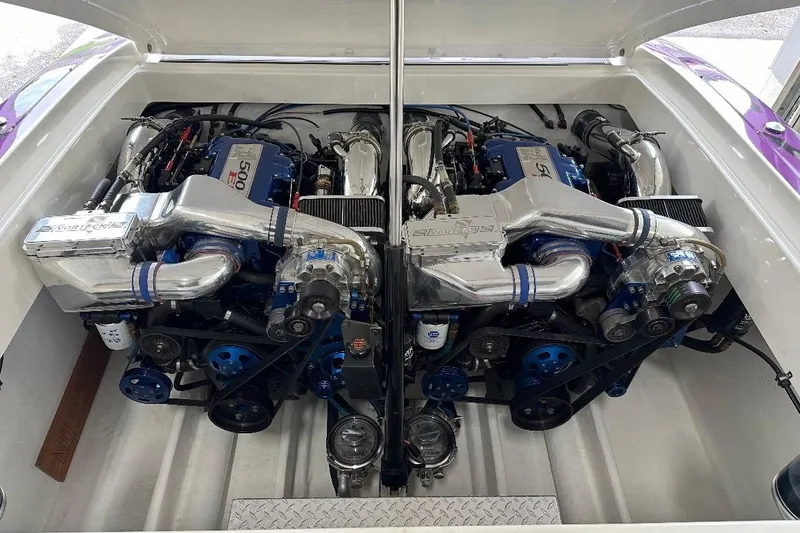 Slide: The Image of Twin engines in a 2000 Hustler 388 SLINGSHOT boat, showcasing high-performance components. - 5