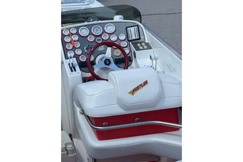Slide: The Image of Cockpit of 2000 Hustler 388 SLINGSHOT with red steering wheel and multiple gauges. - 8