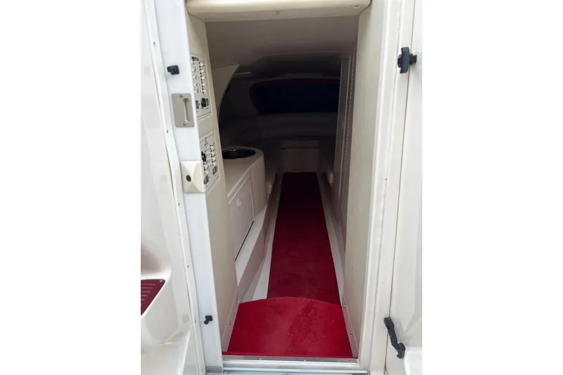 Slide: The Image of Interior cabin of 2000 Hustler 388 SLINGSHOT with red carpet and control panels. - 9