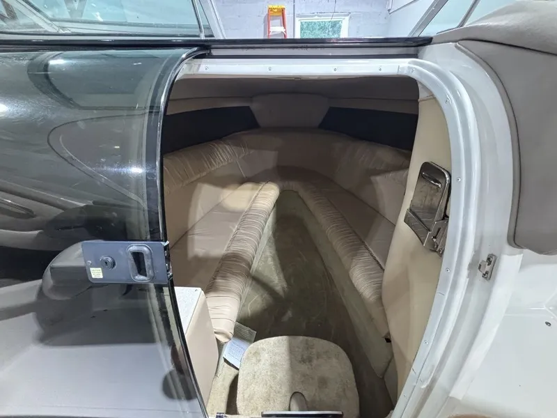 Slide: The Image of Interior cabin of a 2005 Cobalt 255 Express boat, featuring beige seating and carpet. - 10