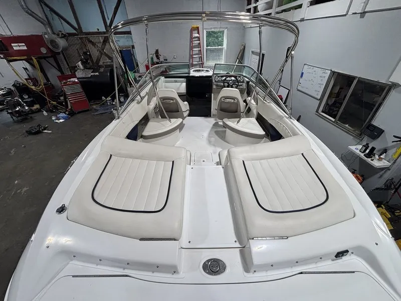 Slide: The Image of 2005 Cobalt 255 Express boat interior with white seating in a workshop setting. - 3