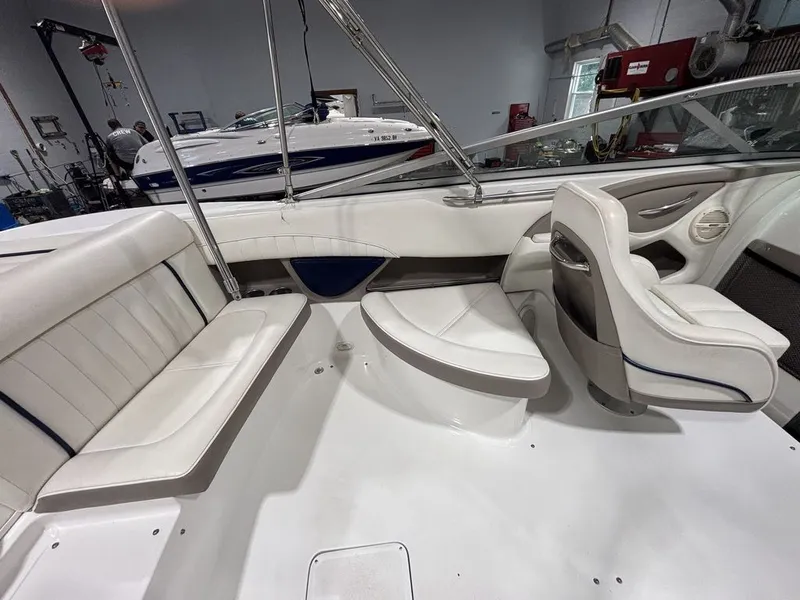 Slide: The Image of 2005 Cobalt 255 Express boat interior with white seating and modern design. - 6