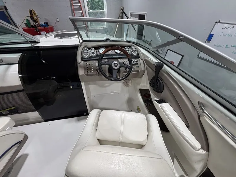 Slide: The Image of Interior of a 2005 Cobalt 255 Express boat, featuring steering wheel and dashboard controls. - 7