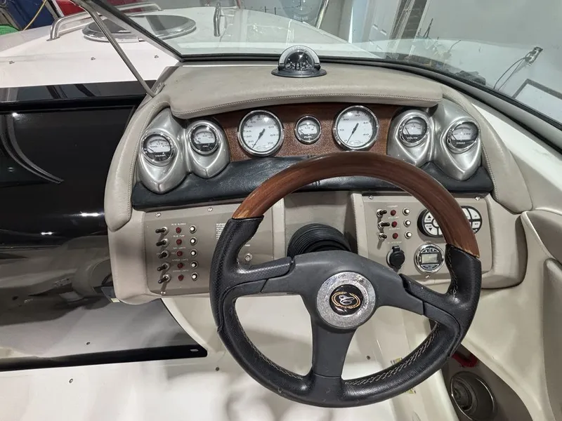 Slide: The Image of Steering wheel and dashboard of a 2005 Cobalt 255 Express boat. - 8
