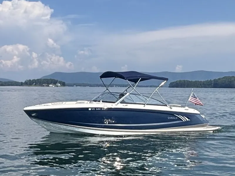 Slide: The Image of 2014 Cobalt A25 boat on a lake with mountains in the background. - 1