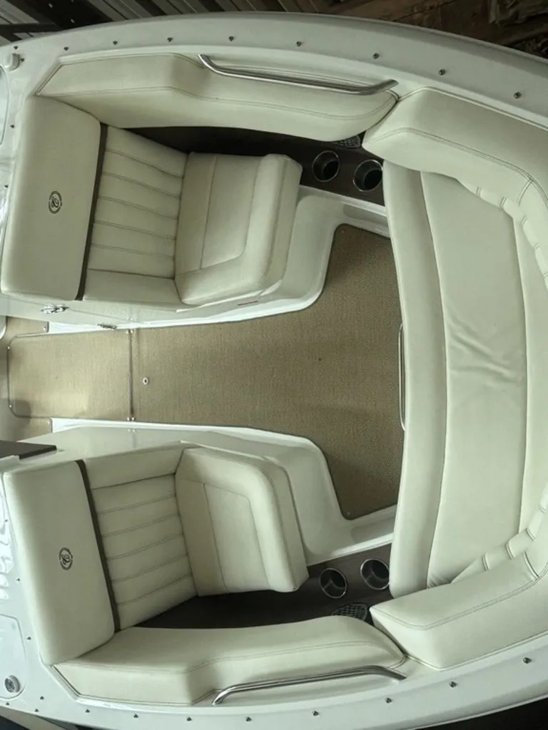 Slide: The Image of 2014 Cobalt A25 boat interior with white leather seating and beige carpet. - 10