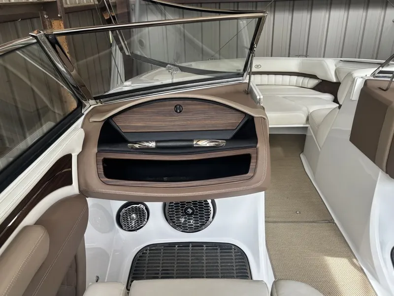 Slide: The Image of 2014 Cobalt A25 boat interior with luxurious seating and modern dashboard design. - 12