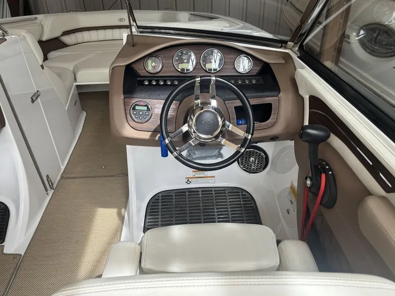 Slide: The Image of 2014 Cobalt A25 boat interior with steering wheel and dashboard controls. - 13